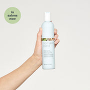 milk-shake-normalizing-blend-shampoo-in-hand